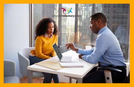 Man and woman talking with computer